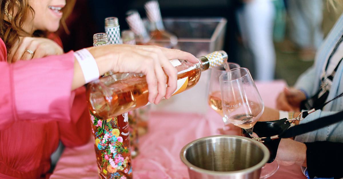 woman pouring pink wine into glass