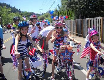 Kids riding bikes decorated for the 4th of July