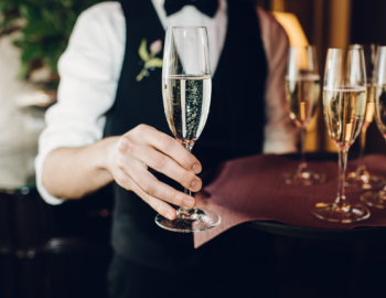 champagne on tray held by server