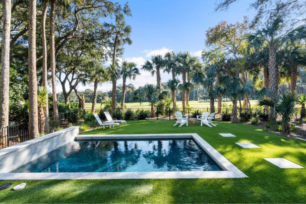 private pool with lounge chairs looking out over kiawah island golf course