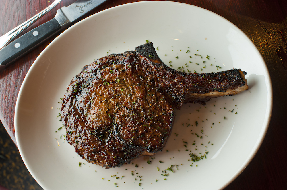 Plated bone-in ribeye steak