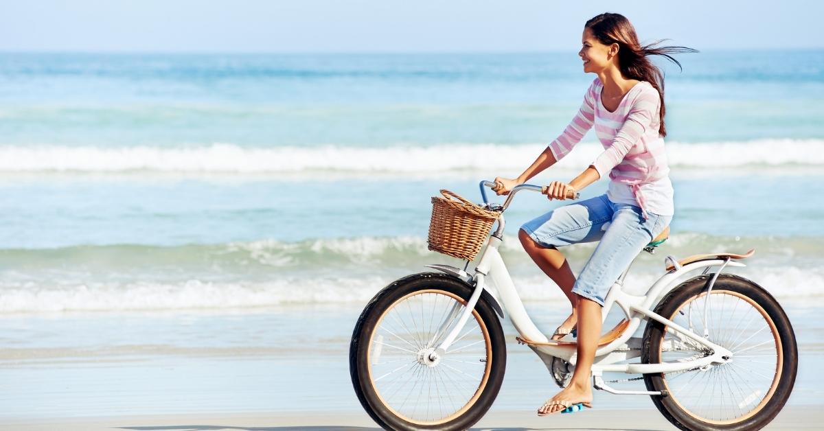 woman riding bicycle on the beach